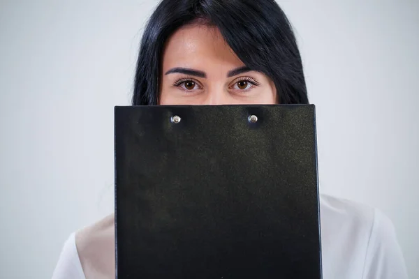 woman teacher, business coach, mentor holds a folder with a new business project in her hands