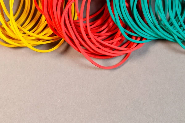 Colored rubber bands for money on a colored background. Stationery accessories