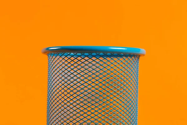 blue metal bucket for office on an orange background