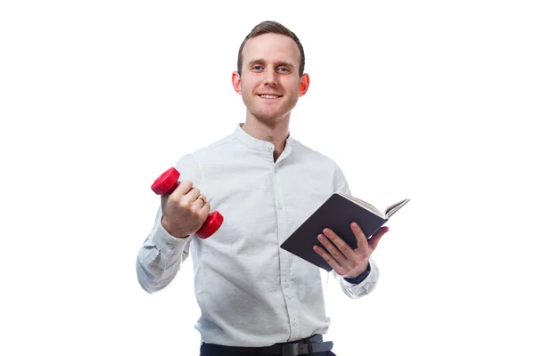 Caucasian man businessman, a teacher mentor. He is holding a diary and red dumbbell. He is wearing a shirt. Emotional portrait. Isolated on white background — Stock Image Caucasian Man Businessman Teacher Mentor Holding Diary Red Dumbbell Wearing Stock Picture