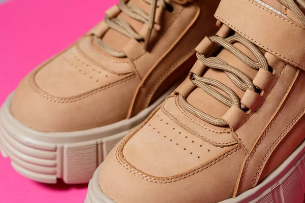 brown leather women shoes with high soles on a pink background. fashion footwear