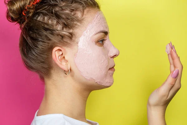 一个年轻貌美的姑娘的画像 她在脸上戴了一个令人神清气爽的面具 以恢复肌肤的活力和光泽 美容疗法 — 图库照片