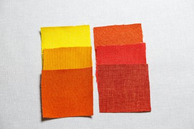 Gri arkaplan üzerine serilmiş çok renkli kumaş parçaları