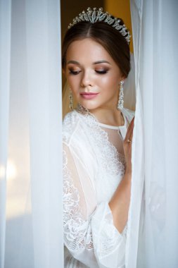 Bir düğün sabahında bornoz ve peçeyle güzel bir gelin