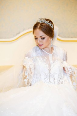 Gelin beyaz gelinliğini giyer