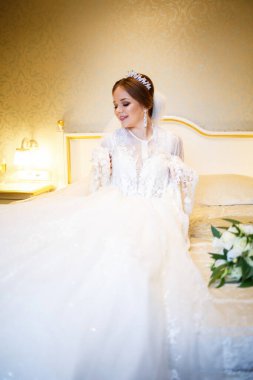 Gelin beyaz gelinliğini giyer