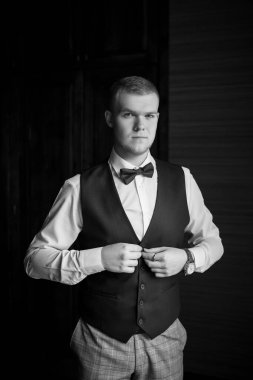 Güzel bir ekose takım elbise ve papyonlu damat.