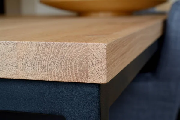 Wooden table top corner closeup.