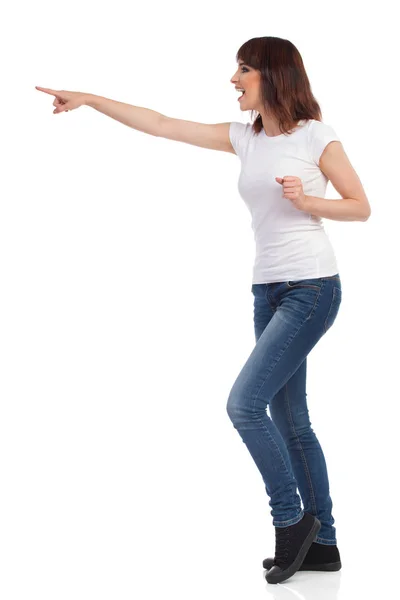 Shouting Young Woman Is Pointing. Side View Isolated