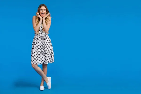 Excited Young Woman On Blue Background