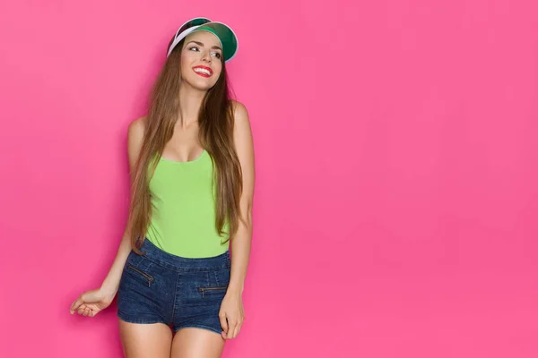 Smiling Young Woman In Green Tank Top Is Looking Away