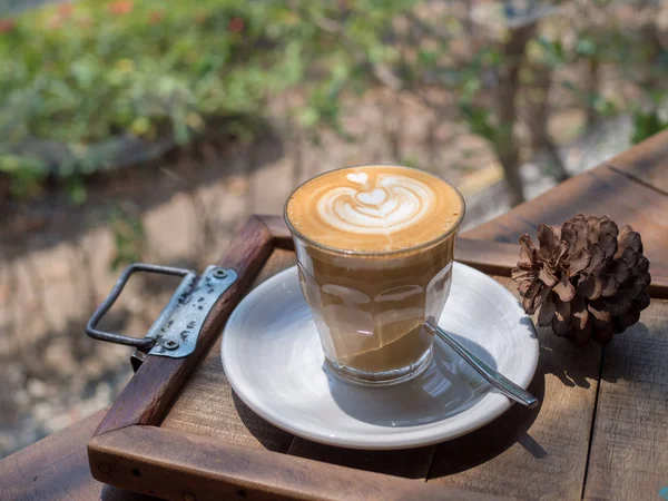 Arte del café con patrón de forma de corazón en la taza en la mesa de madera en el jardín, primer plano de la taza de café con el patrón de forma de corazón. —  Fotos de Stock