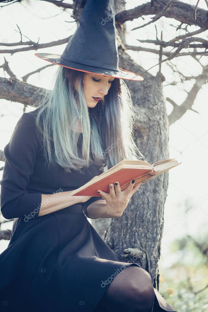 Witch reading a book of magic.