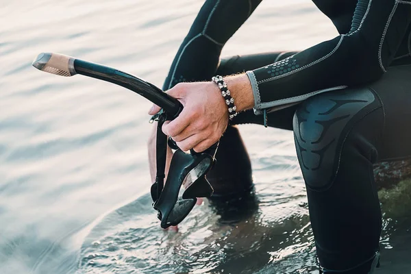 Diver holding snorkel and mask