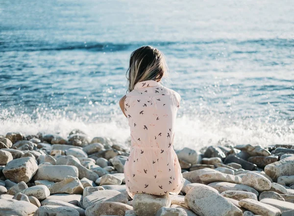 Frau ruht sich am Kiesstrand aus — Stockfoto