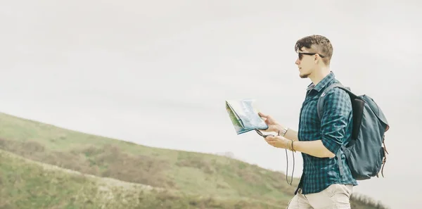 Backpacker searching direction with compass — Stock Photo, Image