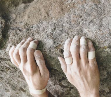 Climbing on rock, view of hands. clipart