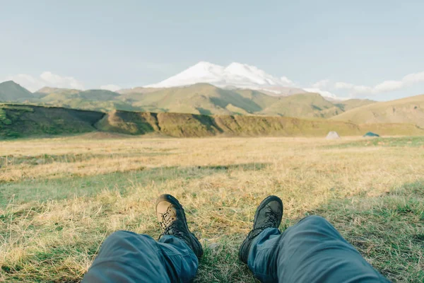 Hombre sentado frente a la montaña Elbrus . — Foto de Stock