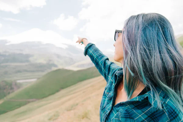 Woman pointing at snowy mountain. — Stock Photo, Image