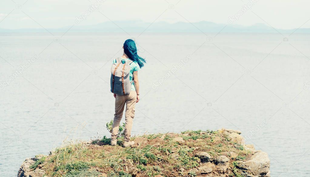 Female backpacker enjoying view of sea. 