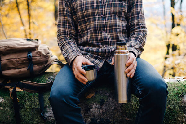 Man resting in autumn forest. 