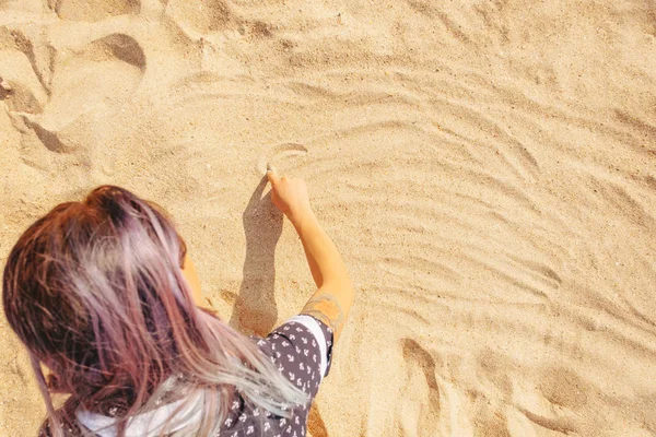 Vrouw trekt op het zand — Stockfoto