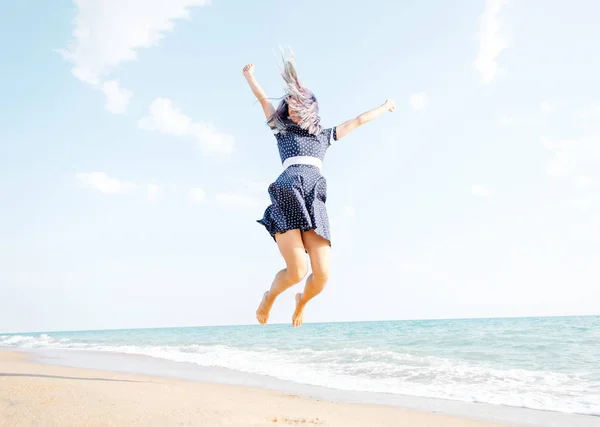 Happy woman jumping on sand beach. — Stock Photo, Image