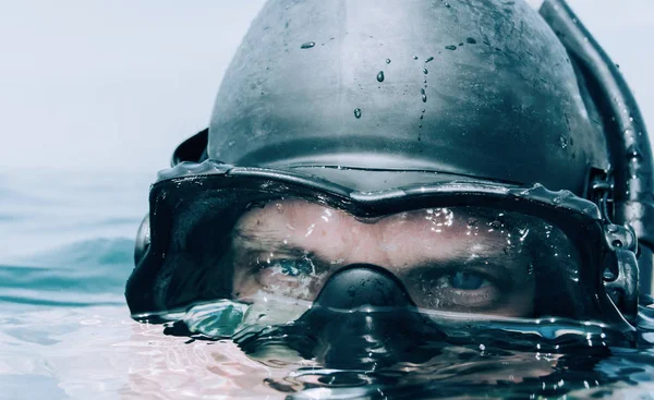 Man diver looking out over the sea. — Stock Photo, Image