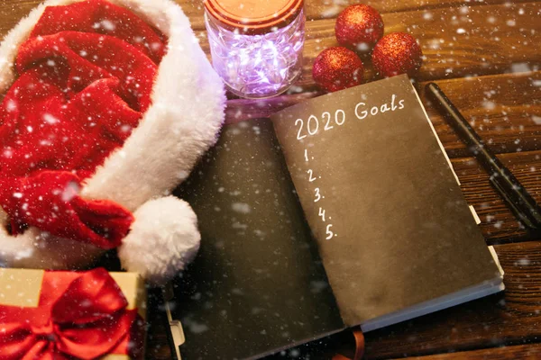 Goals 2020 in notebook near Christmas decorations and snow. — Stock Photo, Image