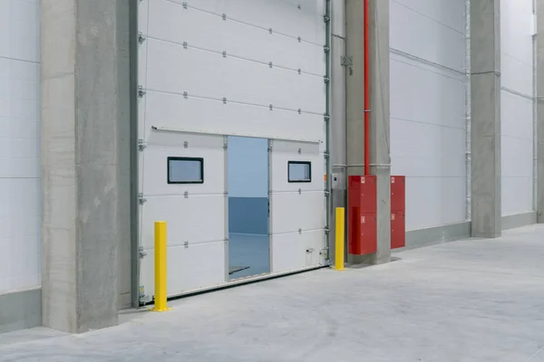 gate in Large modern empty storehouse, nobody