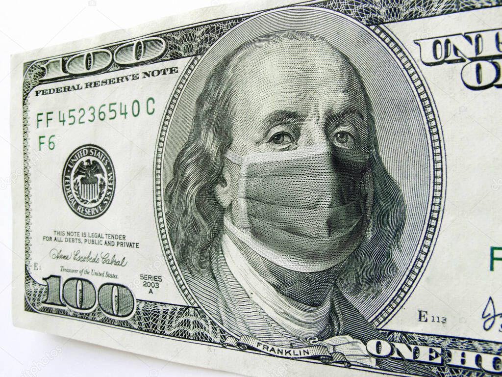 This photo illustration of Ben Franklin wearing a healthcare surgical mask on a one hundred dollar bill illustrates the Coronavirus, the protection of wearing a mask during international travel, and economic costs affecting business, transportation, 