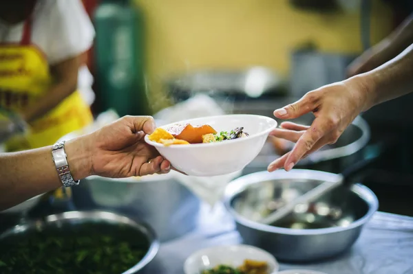 Social hunger: Volunteers provide food assistance to poor people who need food.