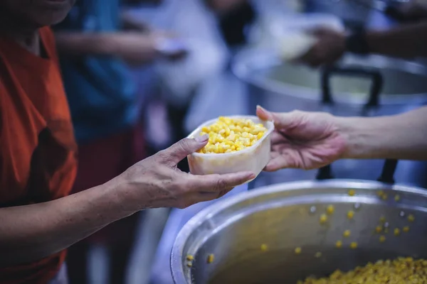 Volunteers give food to needy people, share food to reduce starvation