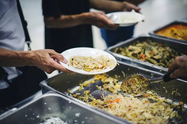 Volunteers give food to needy people, share food to reduce starvation