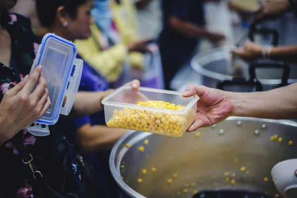 Assisting people with homeless food: Charity: People come to receive free food from volunteers.