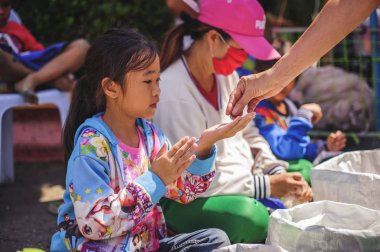Chiang Mai, Tayland - 20 Ekim 2019: Çocuklar ve yoksullar Chiang Mai 'deki hayırseverlerden bağış ve para almak için bekliyorlar
