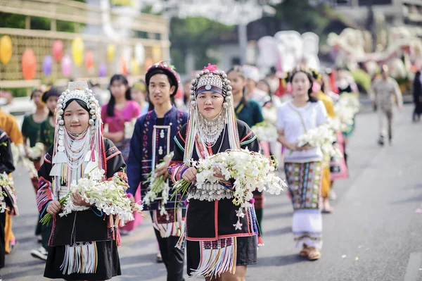CHIANG MAI, THAILAND - FEBRUARY 08, 2020: Young men and women dressed in traditional clothe in the 44th flower festival parade in Chiang Mai, Thailand