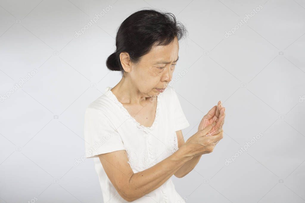 old asian woman feel wrist bones injury