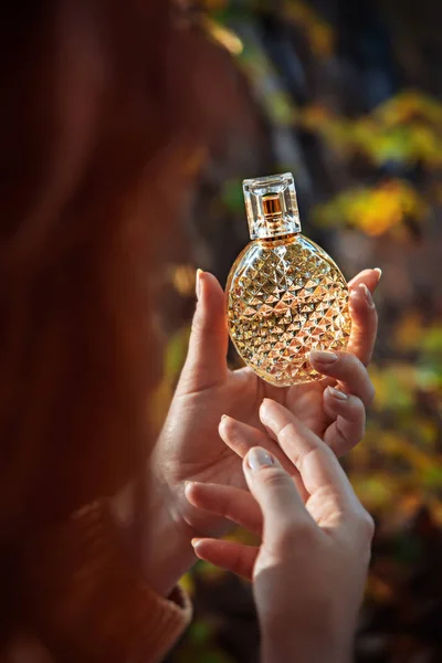 Frasco de perfume en manos femeninas — Foto de Stock