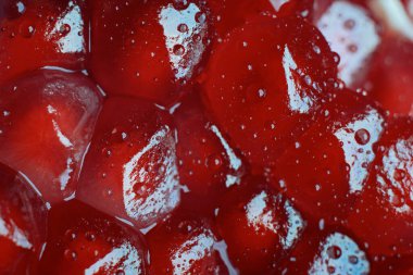 Closeup of peeled pomegranate fruit seeds. Fruit background.
