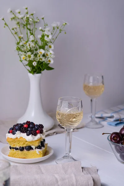 Sponge cake with fresh berries and curd cream for lovers. Summer romantic dessert. Surprise for the beloved.