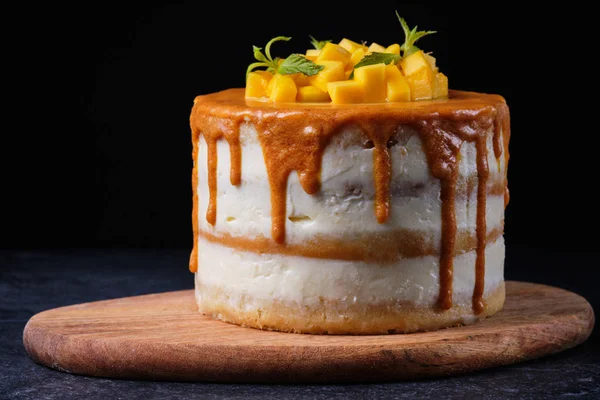 Handmade homemade cake. Mango cake for the holiday. Dessert on a wooden board.