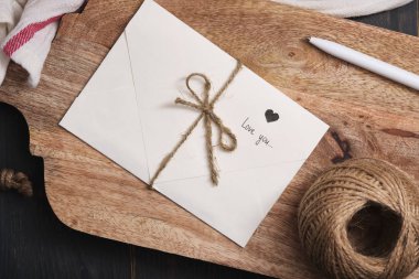 Sevgililer Günü için romantik bir hediye. Eski ahşap bir masada aşk mektubu. Retro biçim fotoğrafı.