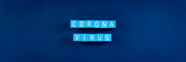 Word corona virus  spelled in white text on light blue blocks in a conceptual image of corona virus outbreak.