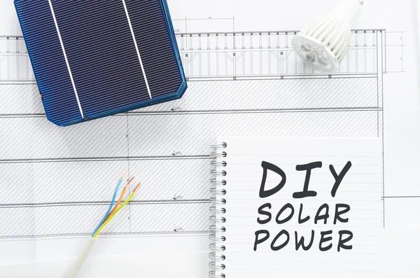 Bir not defterine yazılan DIY güneş enerjisi kavramsal bir resimde bunu kendiniz yapın. Kablolar, kablolar, kablolar ve güneş pilleriyle kurulum yapın.