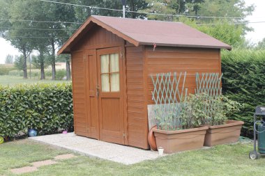 wooden shed for tools in the garden clipart