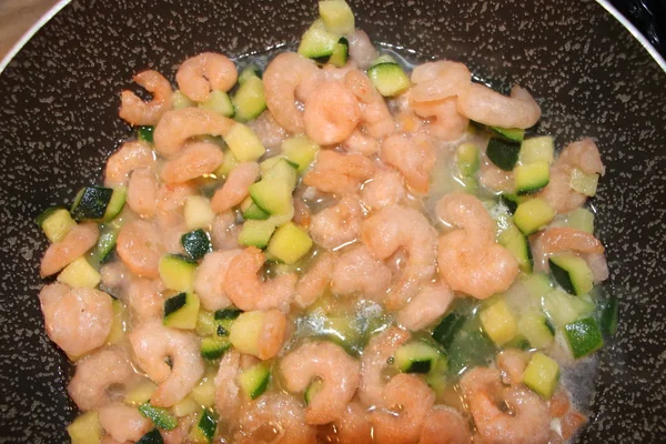 zucchini and shrimp sauce in a pan