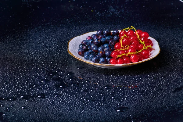 Fresh washed blueberries with drops of water on a background