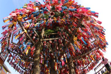 Mae Hong Son , Thailand - Jan 1, 2020: Colorful heart shaped key rings hanging around a tree as a souvenir to visit. 