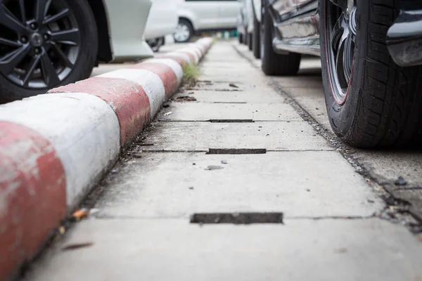 White and red stripes on the sidewalk — Stock Photo, Image